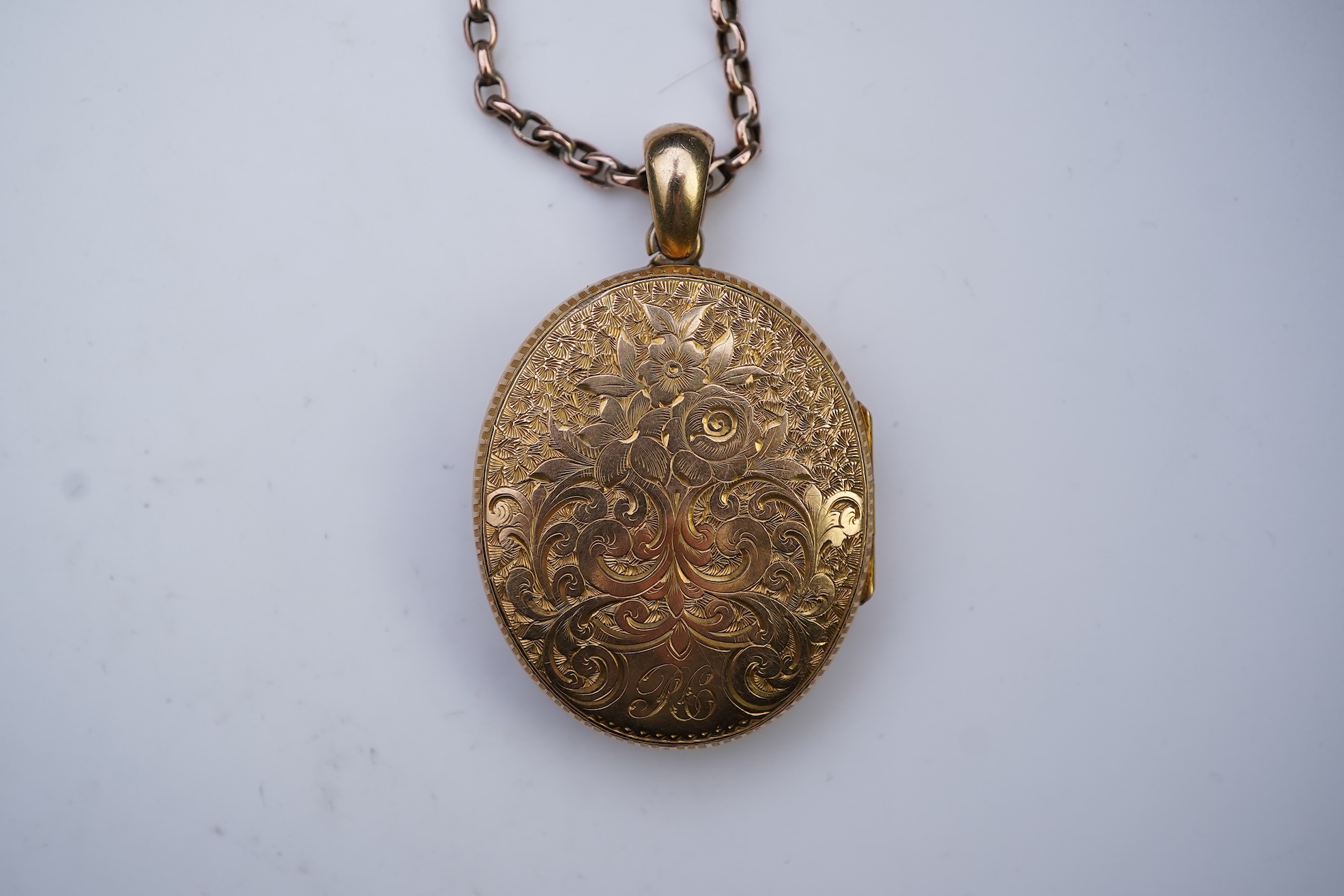 A gold locket and chain, late 19th century